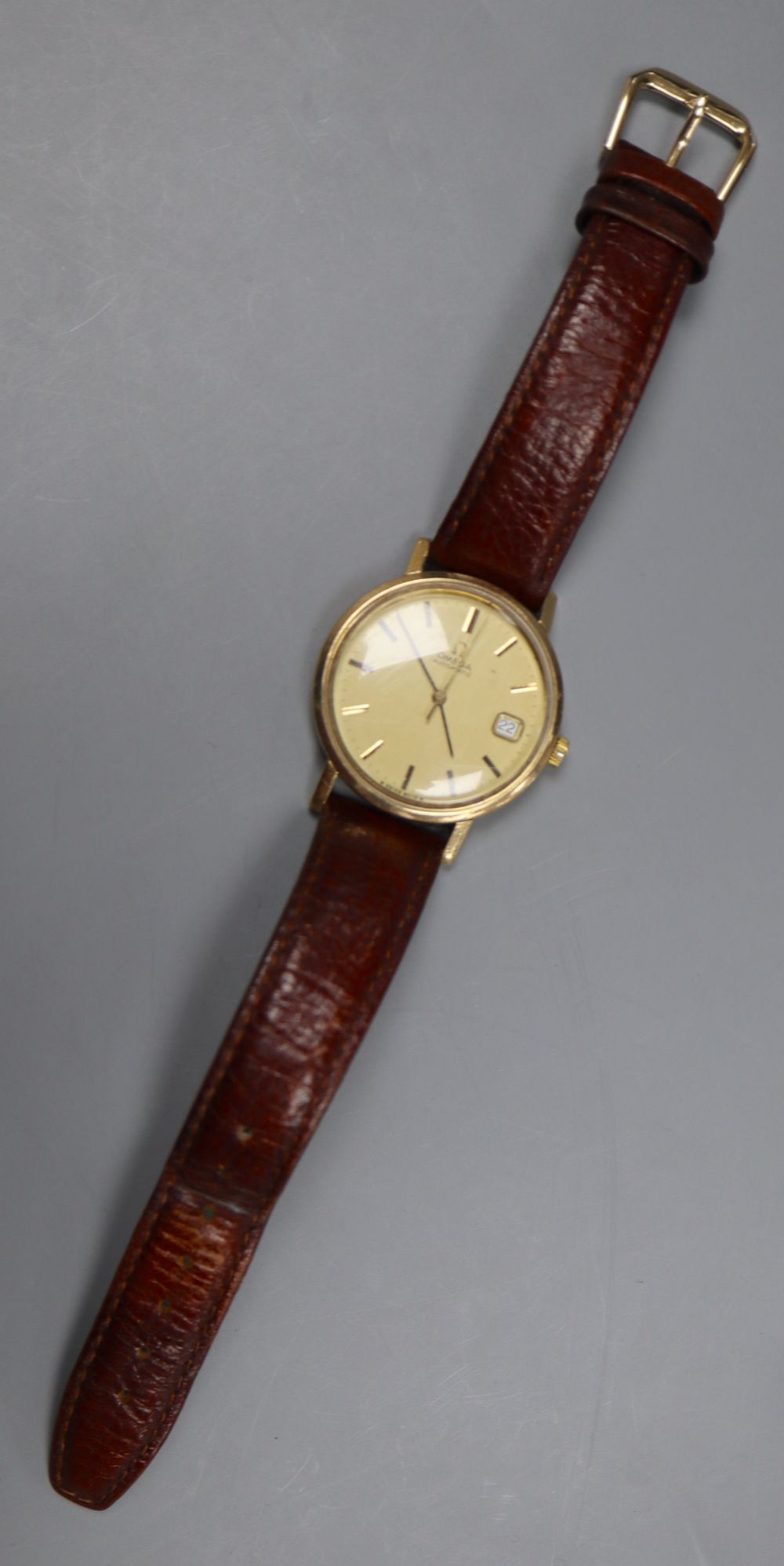 A gentlemans 1970s 9ct gold Omega automatic wrist watch, movement c.1012, movement no. 38167699, on associated strap,